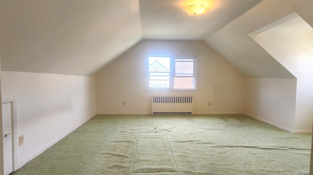 bonus room featuring radiator heating unit, carpet flooring, and lofted ceiling