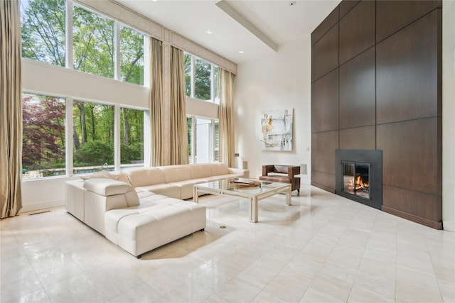 80 Valentines Ln, Old Brookville, NY 11545 - living area with a towering ceiling, a fireplace, and light tile patterned floors