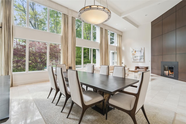80 Valentines Ln, Old Brookville, NY 11545 - dining room with a towering ceiling, light tile patterned floors, healthy amount of natural light, and a fireplace