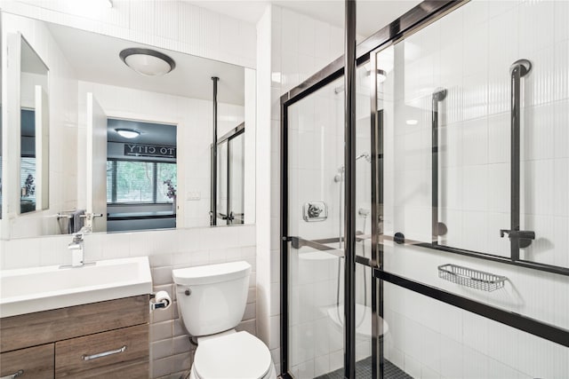 80 Valentines Ln, Old Brookville, NY 11545 - bathroom with tile walls, a shower stall, vanity, and toilet