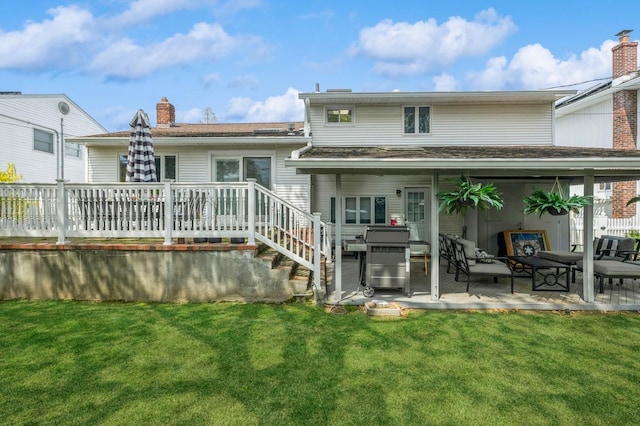 rear view of property with a chimney, a wooden deck, an outdoor hangout area, a yard, and a patio