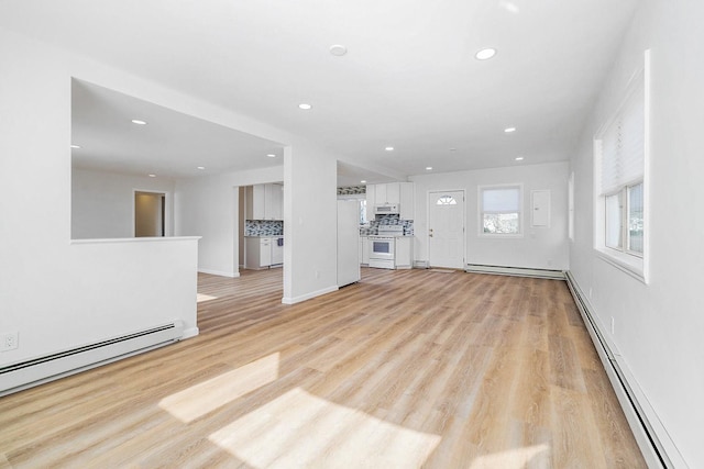 unfurnished living room featuring light wood-style floors, a baseboard radiator, and recessed lighting