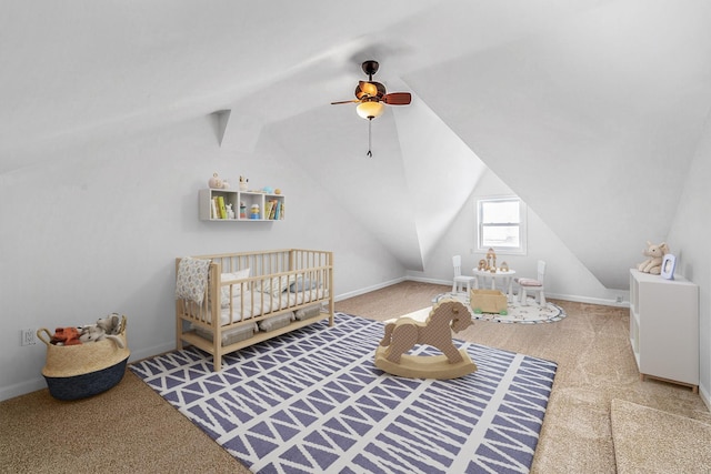 carpeted bedroom with vaulted ceiling with beams, a ceiling fan, and a nursery area