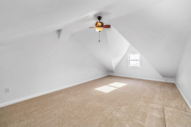 additional living space featuring carpet floors, baseboards, ceiling fan, and lofted ceiling