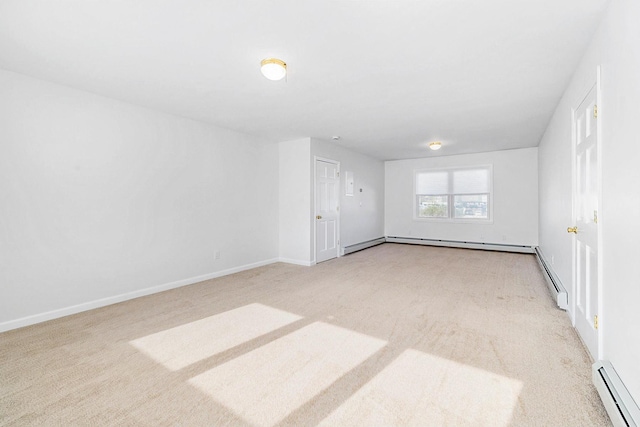 carpeted empty room featuring baseboards and baseboard heating
