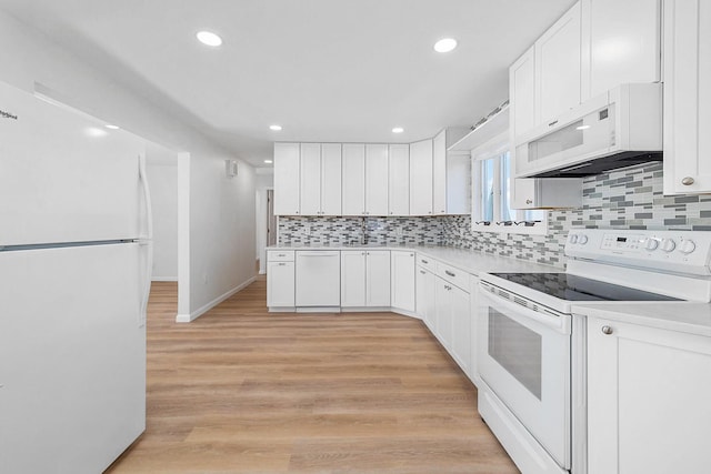 kitchen featuring light countertops, white cabinetry, backsplash, and white appliances