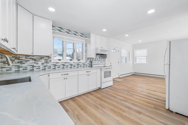 kitchen featuring a sink, white appliances, light countertops, white cabinetry, and tasteful backsplash
