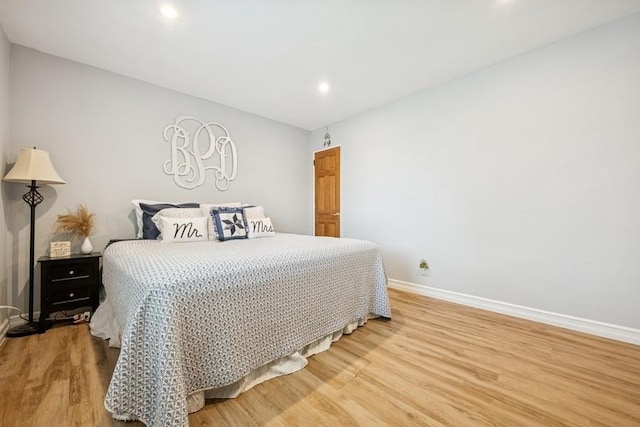 bedroom featuring baseboards, recessed lighting, and light wood finished floors