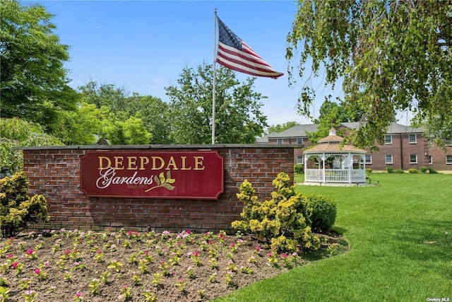 community / neighborhood sign featuring a lawn