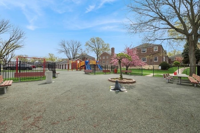 communal playground with fence and a residential view