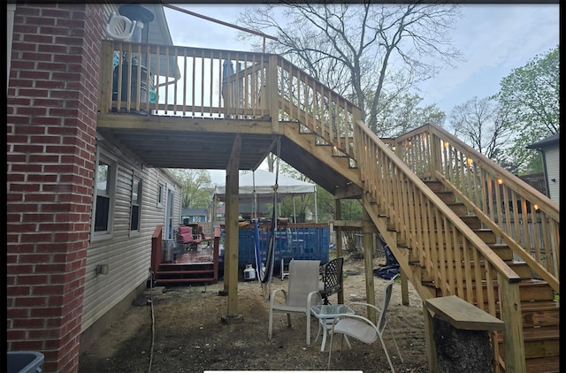 view of patio with a wooden deck and stairway