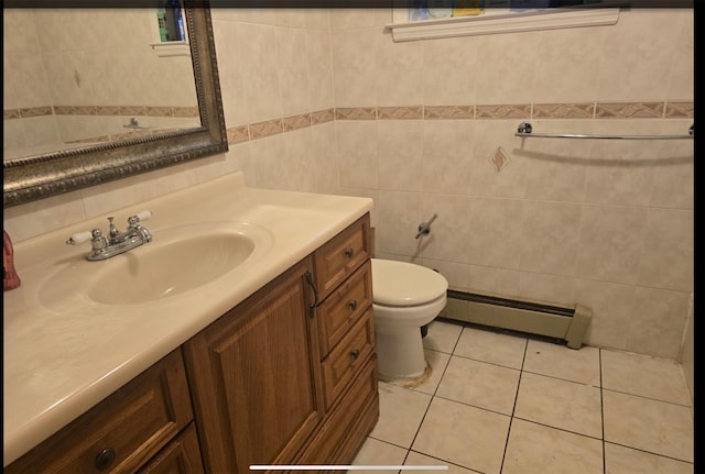 bathroom featuring tile walls, vanity, toilet, tile patterned flooring, and baseboard heating