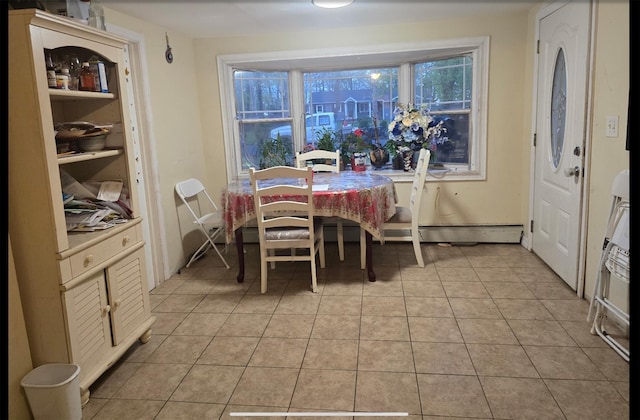 dining area featuring light tile patterned flooring and a baseboard heating unit