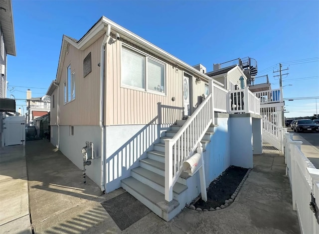 30 Delaware Ave, Long Beach, NY 11561 - view of property exterior featuring stairway and fence