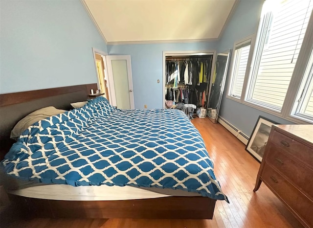 30 Delaware Ave, Long Beach, NY 11561 - bedroom featuring lofted ceiling, crown molding, a baseboard heating unit, and a closet