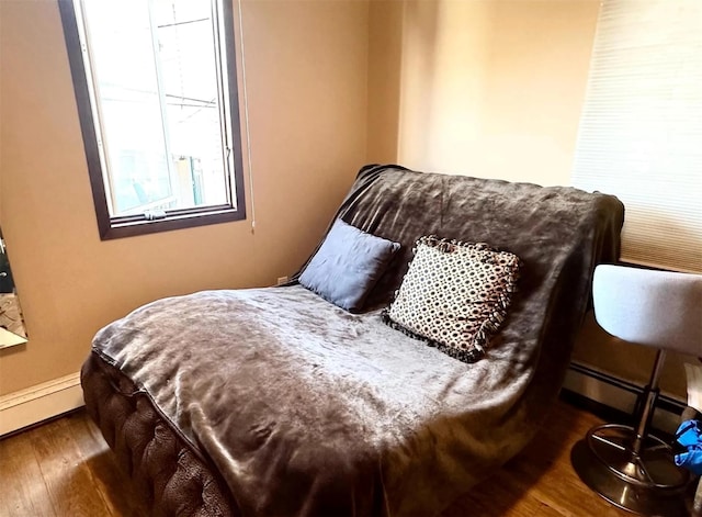 30 Delaware Ave, Long Beach, NY 11561 - bedroom featuring baseboard heating, wood finished floors, and baseboards