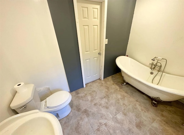 30 Delaware Ave, Long Beach, NY 11561 - bathroom featuring toilet, tile patterned flooring, and a freestanding tub