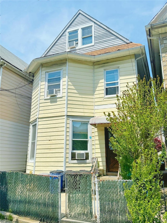 9309 43rd Ave, Elmhurst, NY 11373 - view of front facade featuring a fenced front yard, a gate, and cooling unit