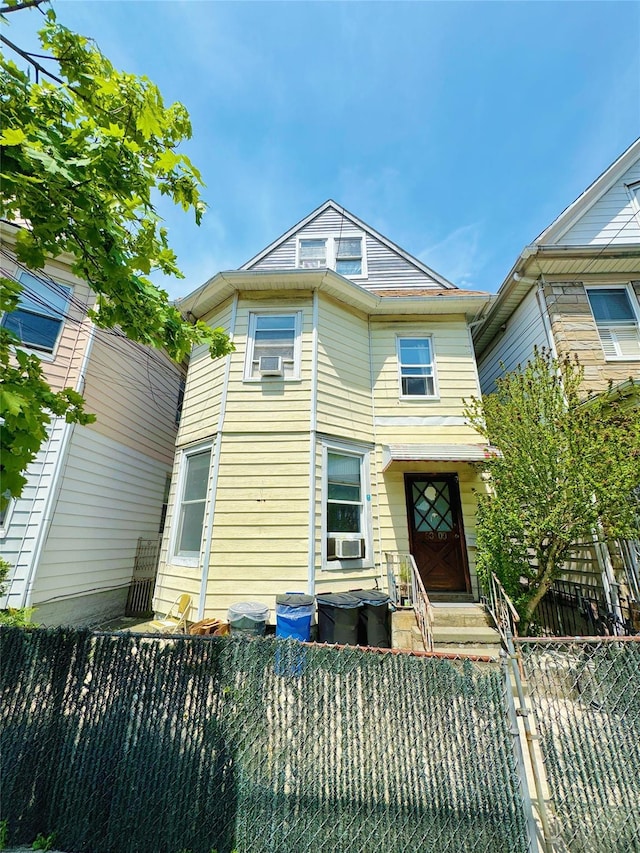 9309 43rd Ave, Elmhurst, NY 11373 - view of front of home featuring cooling unit and a fenced front yard