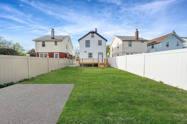 view of yard featuring a fenced backyard and a wooden deck