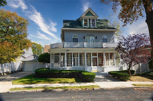 3 Beech Court Cir, College Point, NY 11356 - victorian home featuring fence, a balcony, a sunroom, and a garage