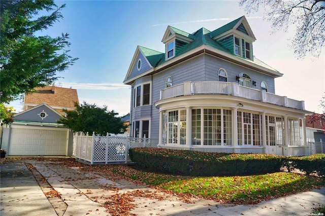 3 Beech Court Cir, College Point, NY 11356 - view of front of house with concrete driveway, fence, a balcony, and a sunroom