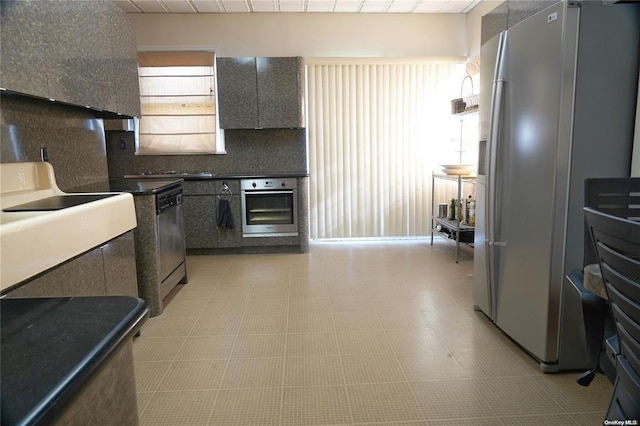 3 Beech Court Cir, College Point, NY 11356 - kitchen with light floors, appliances with stainless steel finishes, backsplash, and dark countertops