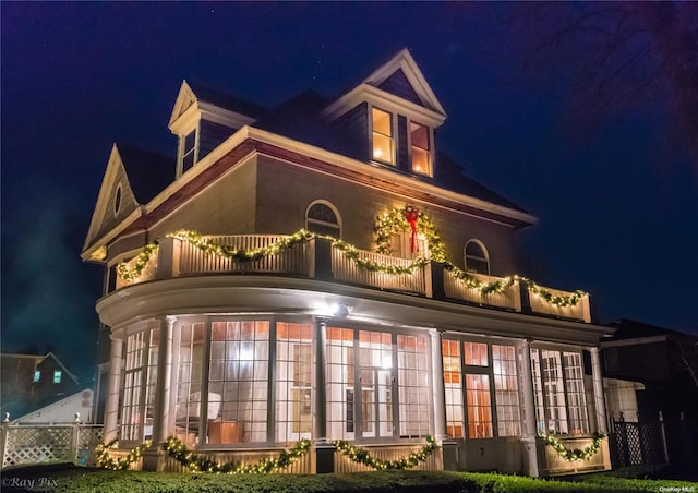 3 Beech Court Cir, College Point, NY 11356 - back of house at twilight featuring french doors, a balcony, and a sunroom