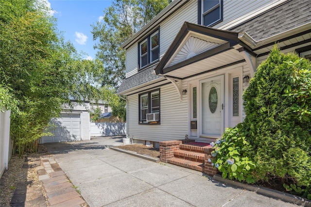47-18 163rd St, Flushing, NY 11358 - property entrance featuring roof with shingles, a garage, driveway, and cooling unit