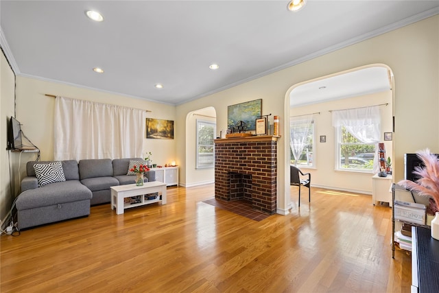 47-18 163rd St, Flushing, NY 11358 - living area featuring crown molding, arched walkways, healthy amount of natural light, a brick fireplace, and wood finished floors