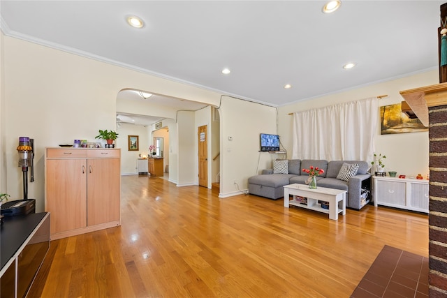 47-18 163rd St, Flushing, NY 11358 - living room with arched walkways, recessed lighting, crown molding, and light wood-style flooring