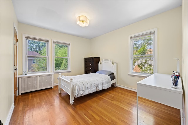 47-18 163rd St, Flushing, NY 11358 - bedroom featuring radiator, multiple windows, and light wood finished floors