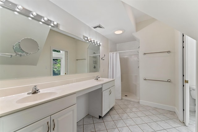 bathroom with a sink, a stall shower, double vanity, and visible vents