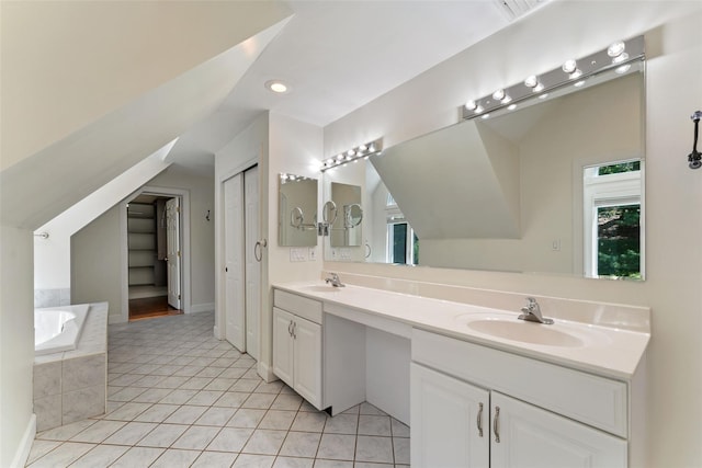 bathroom featuring double vanity, plenty of natural light, a sink, and tile patterned flooring