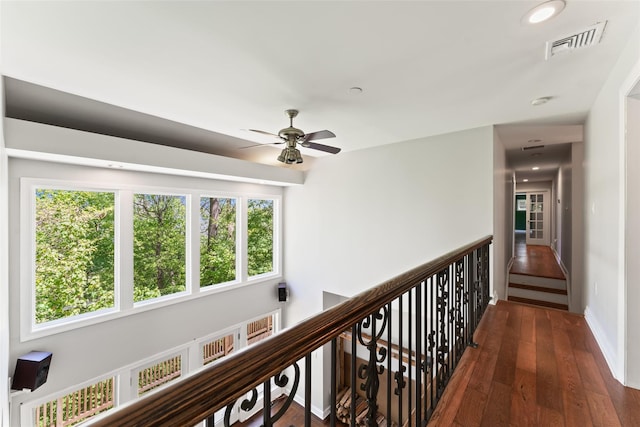 hallway featuring recessed lighting, baseboards, visible vents, and wood finished floors