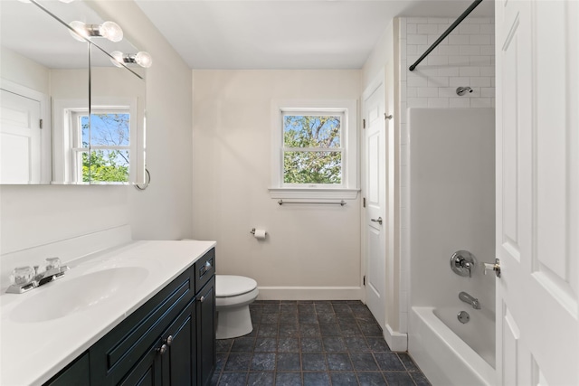 bathroom featuring toilet, baseboards, bathing tub / shower combination, and vanity