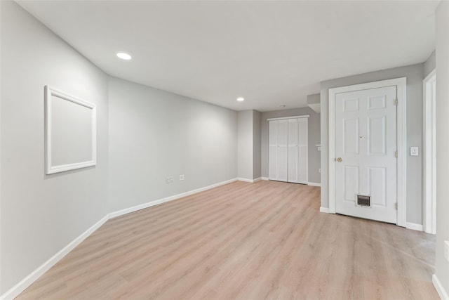 unfurnished bedroom featuring recessed lighting, baseboards, a closet, and light wood-type flooring