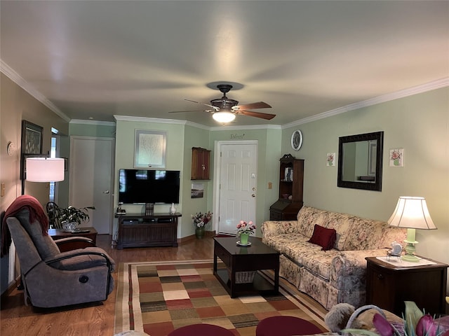 living area with crown molding, ceiling fan, and wood finished floors
