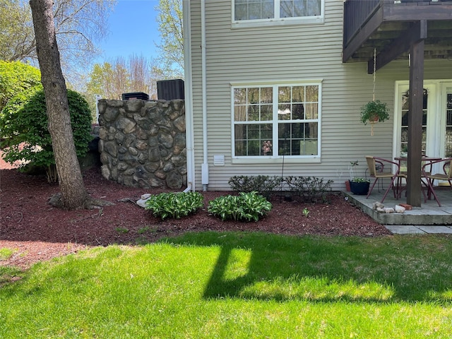 view of side of property featuring a yard and a patio area