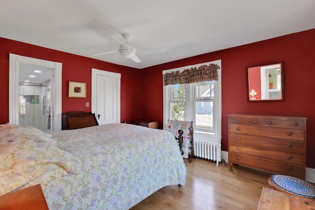 bedroom featuring a ceiling fan, wood finished floors, and radiator