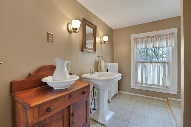 bathroom with radiator heating unit, baseboards, and tile patterned flooring