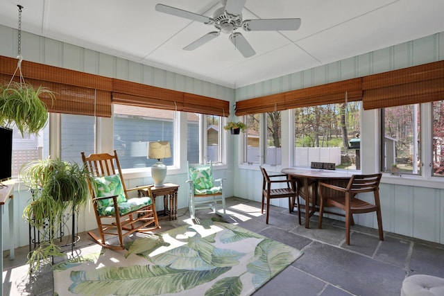 sunroom featuring plenty of natural light, outdoor dining space, and ceiling fan