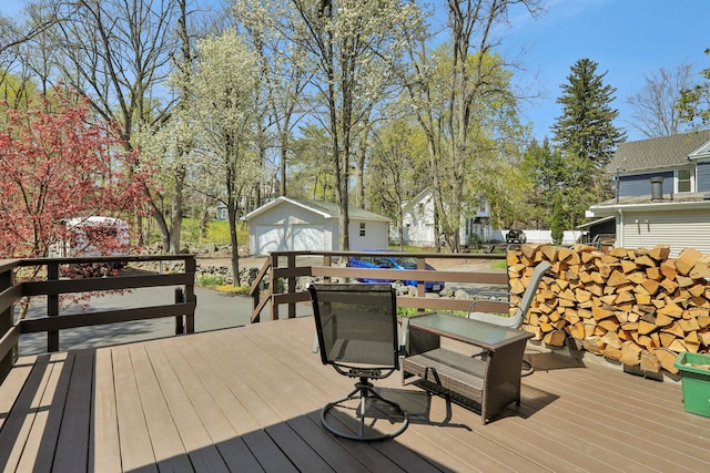 deck with an outdoor structure, a garage, and a residential view