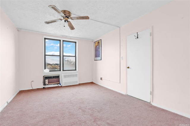 spare room featuring a textured ceiling, carpet, ceiling fan, and radiator heating unit