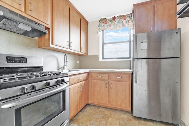 kitchen with appliances with stainless steel finishes, a sink, light countertops, stone finish floor, and under cabinet range hood