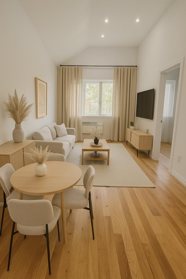 living area with recessed lighting, vaulted ceiling, and light wood-type flooring