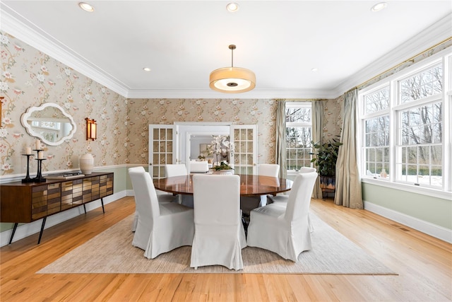 dining area featuring wallpapered walls, light wood-style floors, and ornamental molding