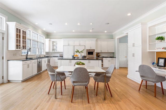 dining room featuring recessed lighting, ornamental molding, and light wood-type flooring