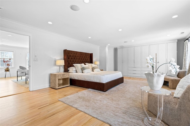 bedroom with crown molding, light wood-type flooring, and recessed lighting