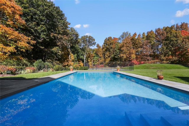 pool featuring a yard and fence